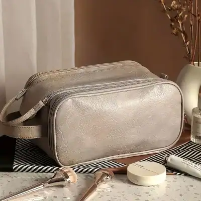 Elegant beige cosmetic bag with multiple compartments for skincare, makeup tools, and beauty essentials. Perfect for organizing and travel.