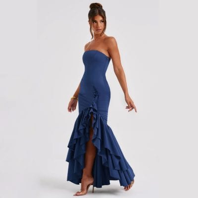 A stunning woman wearing a strapless navy blue gown with dramatic ruffles and a high slit, perfect for formal events, parties, or celebrations.