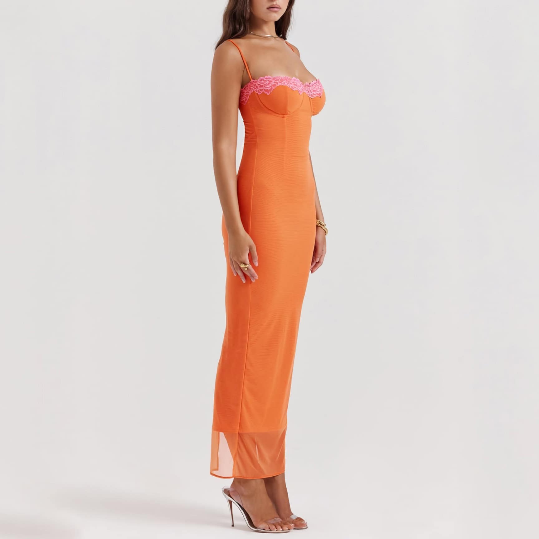 A stunning orange gown featuring pink lace accents at the bust, modern fitted silhouette, spaghetti straps, and a sheer hem, perfect for formal occasions.