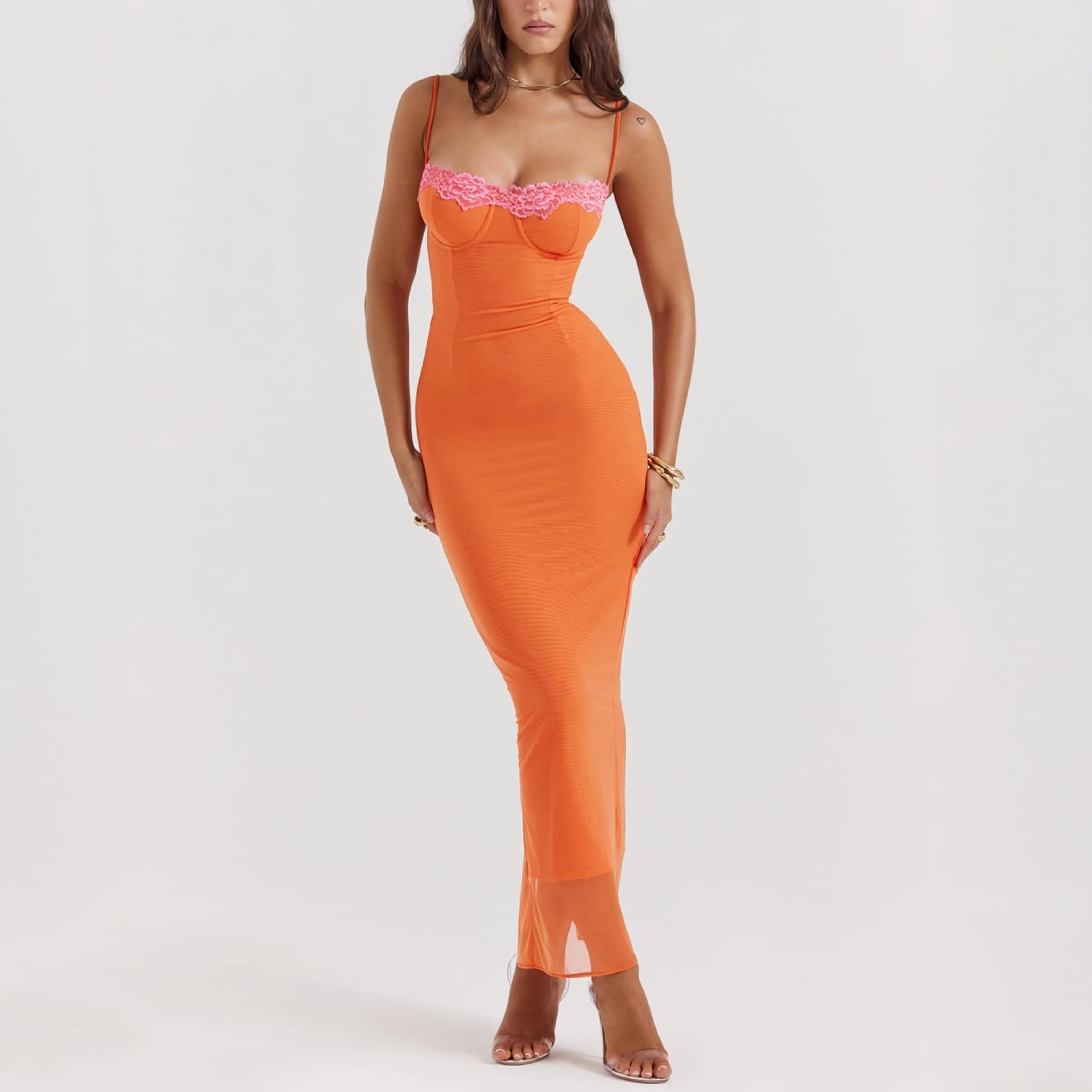 Stylish orange maxi dress featuring pink lace accents, perfect for fashionable outings and special occasions. The form-fitting design enhances your silhouette, paired with clear heels for a chic look.