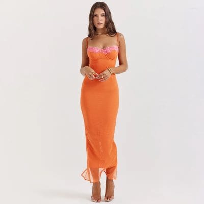 Fashionable orange dress with pink lace accents, body-hugging fit, and spaghetti straps. Perfect for stylish occasions and evening events, highlighting confidence and chic style.