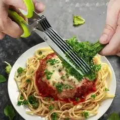 Healthy parsley garnish on cooked spaghetti with cheese and tomato sauce, on a white plate, with fresh herbs in the background.