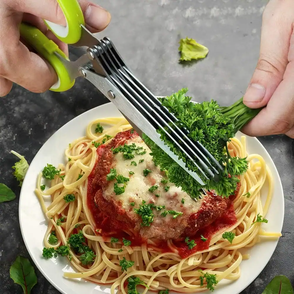 Healthy parsley garnish on cooked spaghetti with cheese and tomato sauce, on a white plate, with fresh herbs in the background.