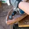Handcrafting wood with power drill and chisel for custom wooden art.