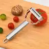 A stainless steel tomato peeler with sharp blades for easy peeling of tomatoes, on a wooden cutting board alongside cherry and green tomatoes, perfect for food preparation.