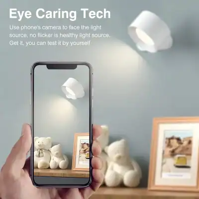A person uses their smartphone camera to scan a white lamp, demonstrating innovative eye care technology for healthy lighting and flicker-free light sources.