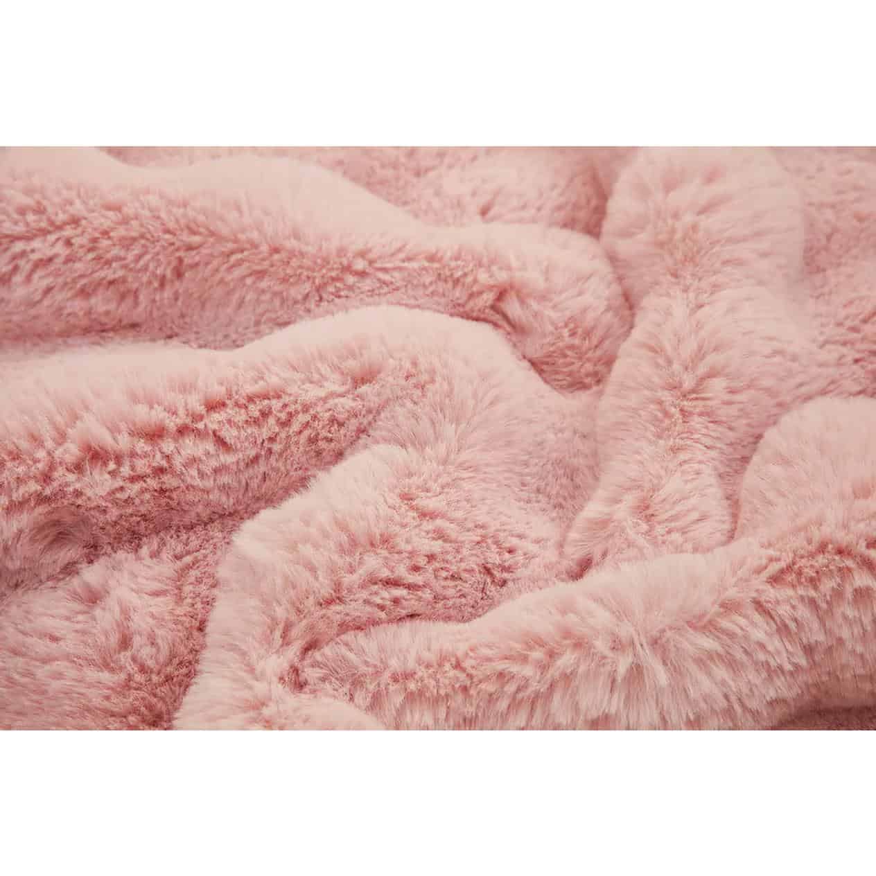Close-up image of a soft, pink plush fabric, showcasing its fuzzy and fluffy texture, ideal for blankets, throws, and cozy accessories at Monalisa Store.