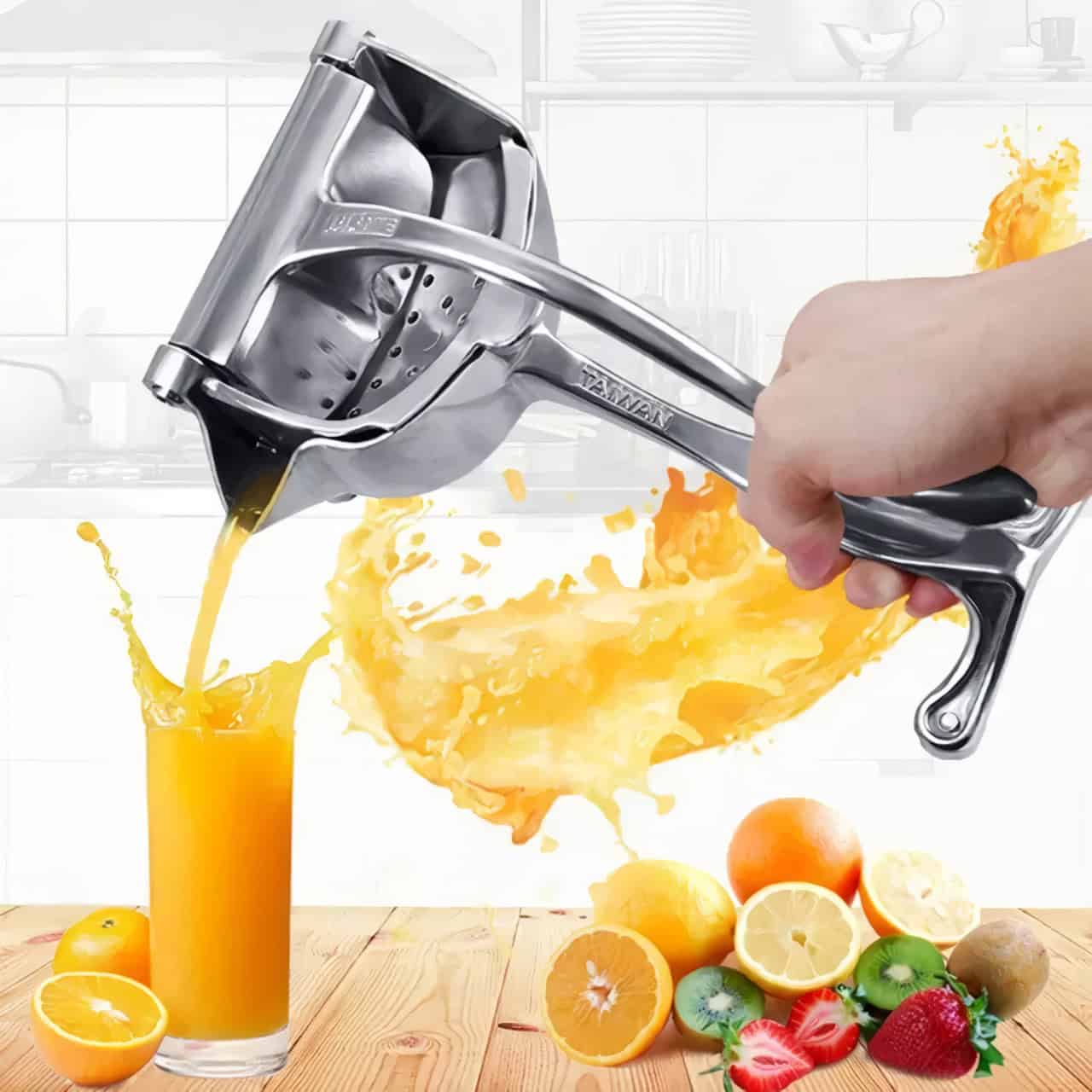 Bright orange juice pouring from a stainless steel juicer into a glass, with fresh oranges, lemons, strawberries, and kiwis on a wooden table, emphasizing healthy lifestyle and fresh ingredient use.