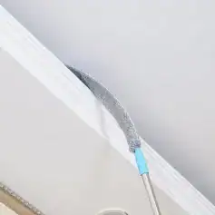 High-quality microfiber duster cleaning ceiling and wall surfaces, ideal for removing dust and cobwebs efficiently in home or office environments.