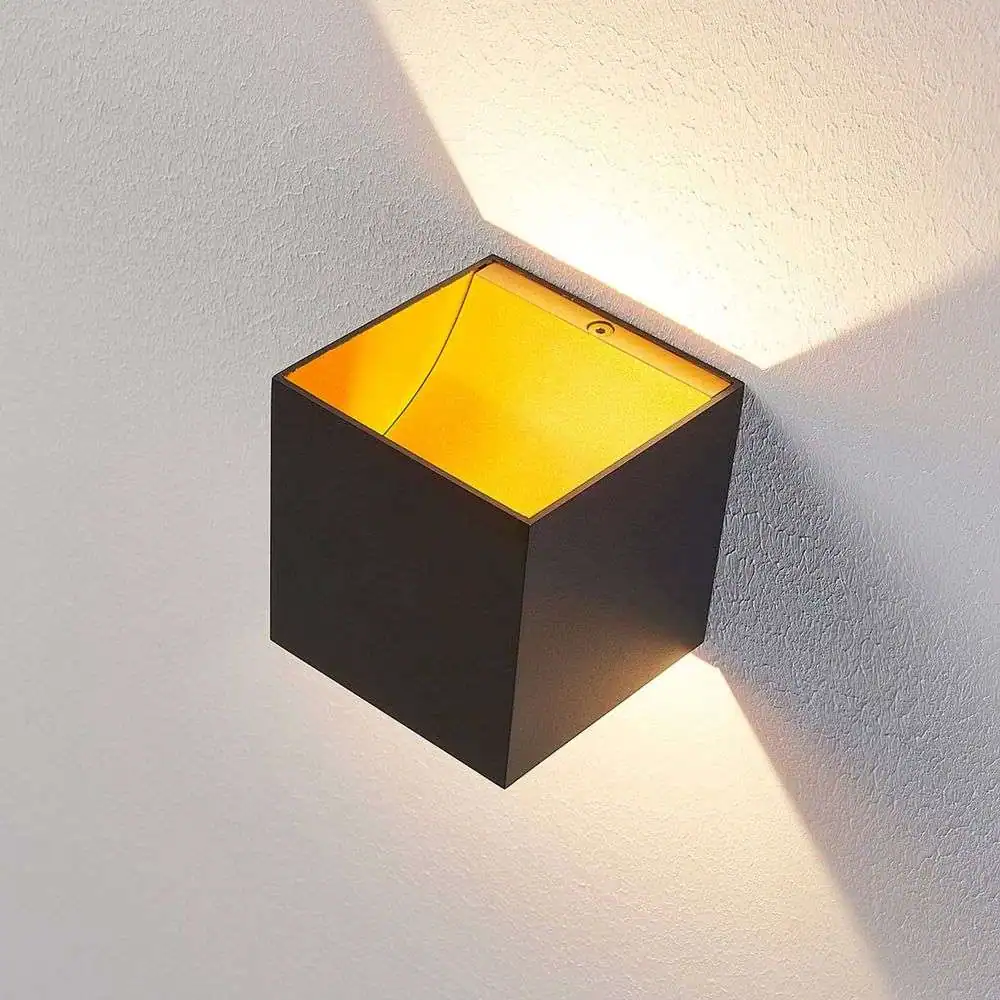 Contemporary wall-mounted light with a sleek black finish and warm yellow glow, perfect for enhancing ambiance in living rooms, bedrooms, or commercial spaces.