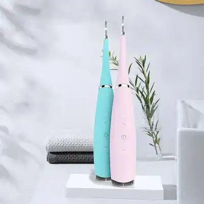 Two pastel-colored electric dental scalers with sleek design, displayed on a white surface with a modern background, suitable for professional teeth cleaning at Monalisa Store.