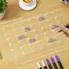 Organized monthly planner on a transparent acrylic sheet with handwritten notes for appointments like family dinner, bake a cake, and BBQ, ideal for efficient scheduling and time management.