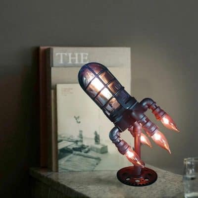 A steampunk-inspired rocket lamp with a metallic design and glowing flames, ideal for modern home decor and lighting aesthetics. Perfect for enthusiasts of unique, industrial-inspired lighting fixtures.
