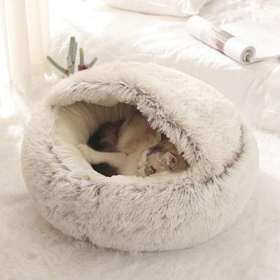 Soft plush cat bed with a rounded design perfect for small cats and kittens to rest comfortably indoors. Provides warmth and security, ideal for relaxing and napping.