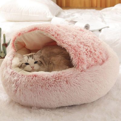Soft plush pink cat bed with cozy enclosed dome design for cats, perfect for comfort and relaxing sleep.