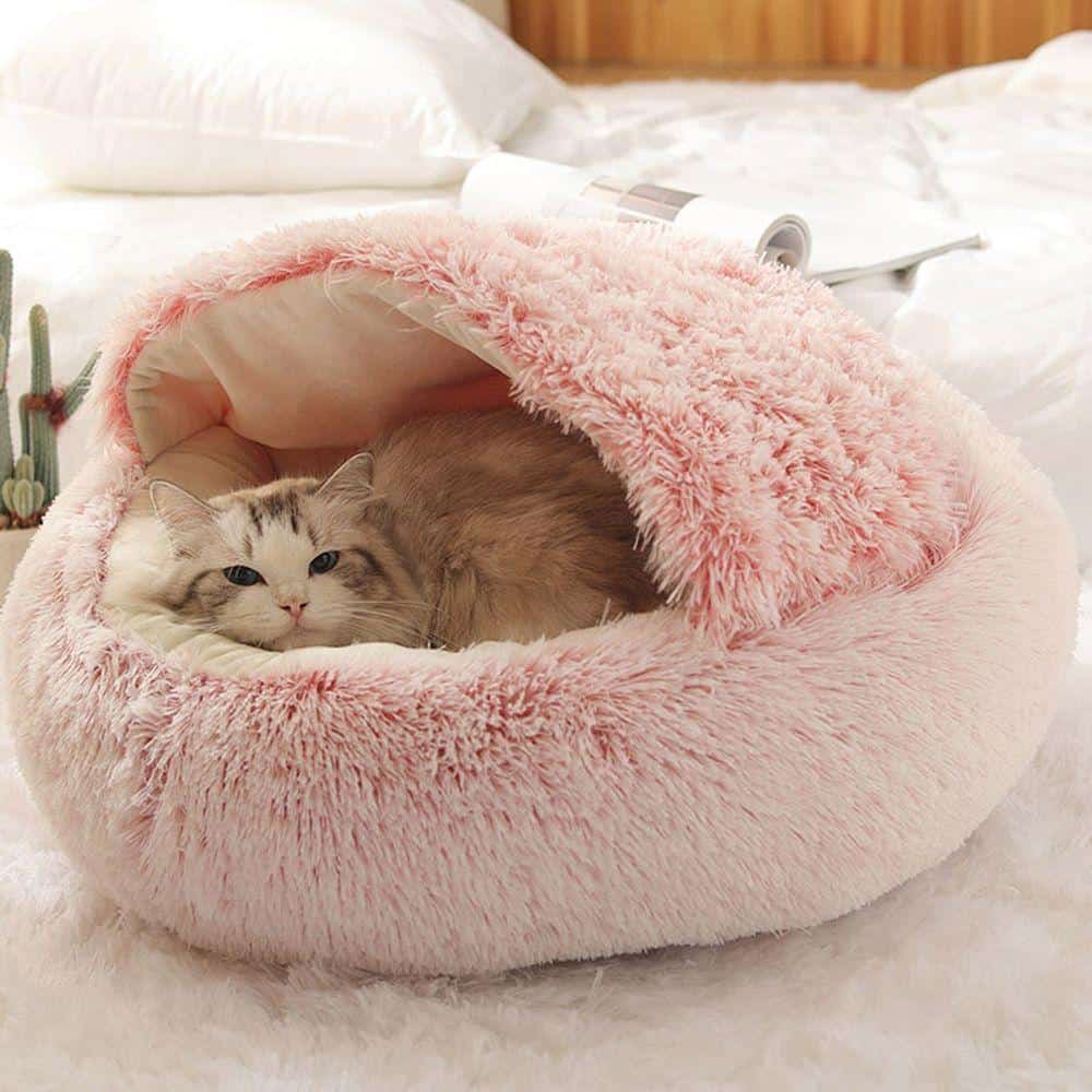 Soft plush pink cat bed with cozy enclosed dome design for cats, perfect for comfort and relaxing sleep.