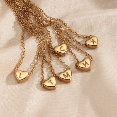 Gold heart-shaped necklace with engraved letters, perfect jewelry gift for loved ones.