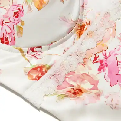 Close-up of floral satin pajamas with delicate lace accents, perfect for comfortable and stylish sleepwear in feminine designs.