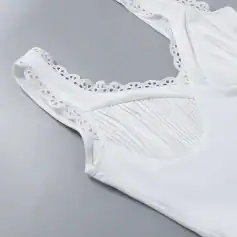 White lace-trimmed sleeveless top with intricate detailing for stylish everyday wear. Perfect for casual or dressy occasions, combining comfort and elegance seamlessly.
