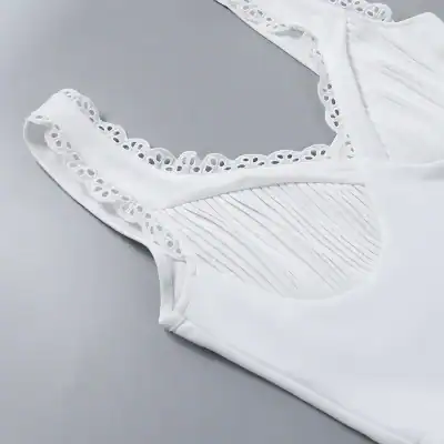 White lace-trimmed sleeveless top with intricate detailing for stylish everyday wear. Perfect for casual or dressy occasions, combining comfort and elegance seamlessly.