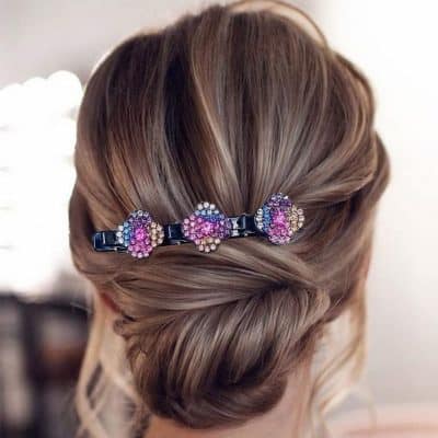Colorful hair clip with purple, pink, and white rhinestones, perfect for elegant hairstyles, available at Monalisa Medical Store.