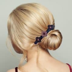 Blonde hair styled in a smooth, elegant bun secured with a decorative floral hair clip at Monalisa Store. Perfect for special occasions or daily style enhancements.