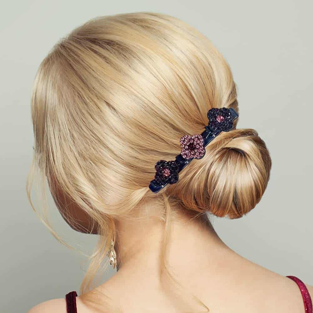 Blonde hair styled in a smooth, elegant bun secured with a decorative floral hair clip at Monalisa Store. Perfect for special occasions or daily style enhancements.
