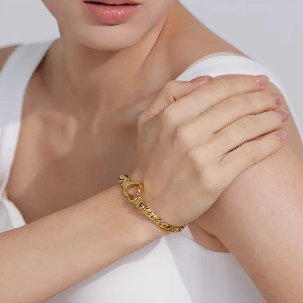 Close-up of a woman's wrist adorned with a stylish gold bracelet, emphasizing jewelry options available at Monalisa Store for enhancing your beauty and fashion.