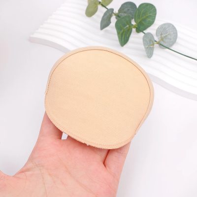 A beige, soft, adhesive surgical underlay patch used for medical procedures, designed for comfort and secure fitting, suitable for various treatments in aesthetic and medical contexts.