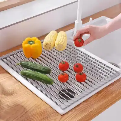 Fresh vegetables including yellow bell pepper, corn, cucumbers, and tomatoes arranged on a modern kitchen rack, emphasizing freshness and quality at Monalisa Store.