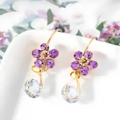 Luxurious gold earrings with purple gemstones and crystal drops, perfect for sophisticated jewelry collection.