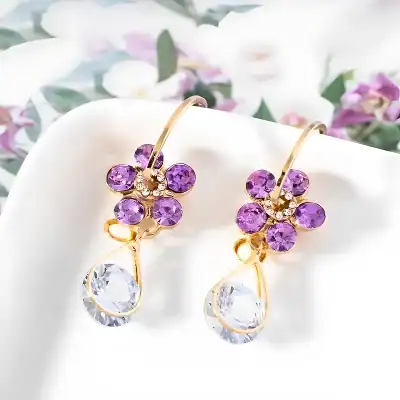 Luxurious gold earrings with purple gemstones and crystal drops, perfect for sophisticated jewelry collection.