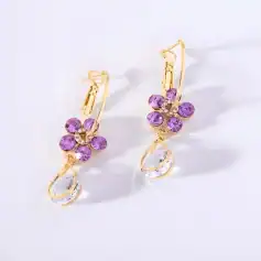 Beautiful gold earrings with purple gemstones and teardrop crystal accents, perfect for stylish jewelry accessories and enhancements.