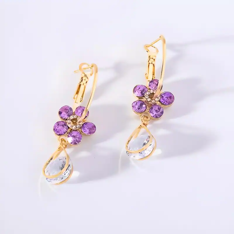 Beautiful gold earrings with purple gemstones and teardrop crystal accents, perfect for stylish jewelry accessories and enhancements.