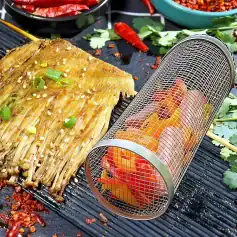 Delicious grilled fish topped with green onions, served with chili and herbs on a black grill mat. Perfect for healthy seafood meals and outdoor barbecues.