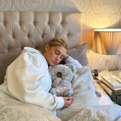 Soft, comfortable sleeping environment with plush teddy bear, sophisticated bedding, and warm bedside lighting, highlighting quality sleep essentials and stylish bedroom decor from Monalisa Medical Store.