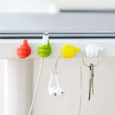 Vivid thumb-shaped hooks in red, green, yellow, and white hold chargers, earphones, and keys, adding a playful, functional touch to your space.