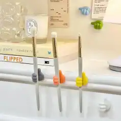 Colorful hand grips holding skincare brushes on a white shelf.