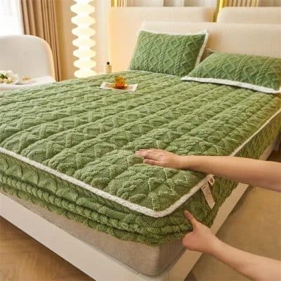 Soft green mattress with quilted design, perfect for a restful sleep, featured at Monalisa Medical Store. Unique shape for added comfort and style.