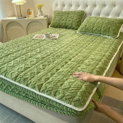 Comfortable, plush green quilted mattress protector for enhanced sleep quality and protection. Perfect for adding a touch of elegance to your bedroom decor.