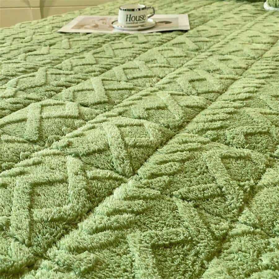 Luxurious green textured rug with intricate geometric pattern, perfect for living room or bedroom decor. Durable and soft, enhances the cozy ambiance of your home.