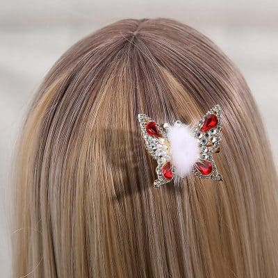 Elegant butterfly hair accessory with red gemstones and white fluffy center for stylish hair embellishments. Perfect for adding a charming touch to any hairstyle.