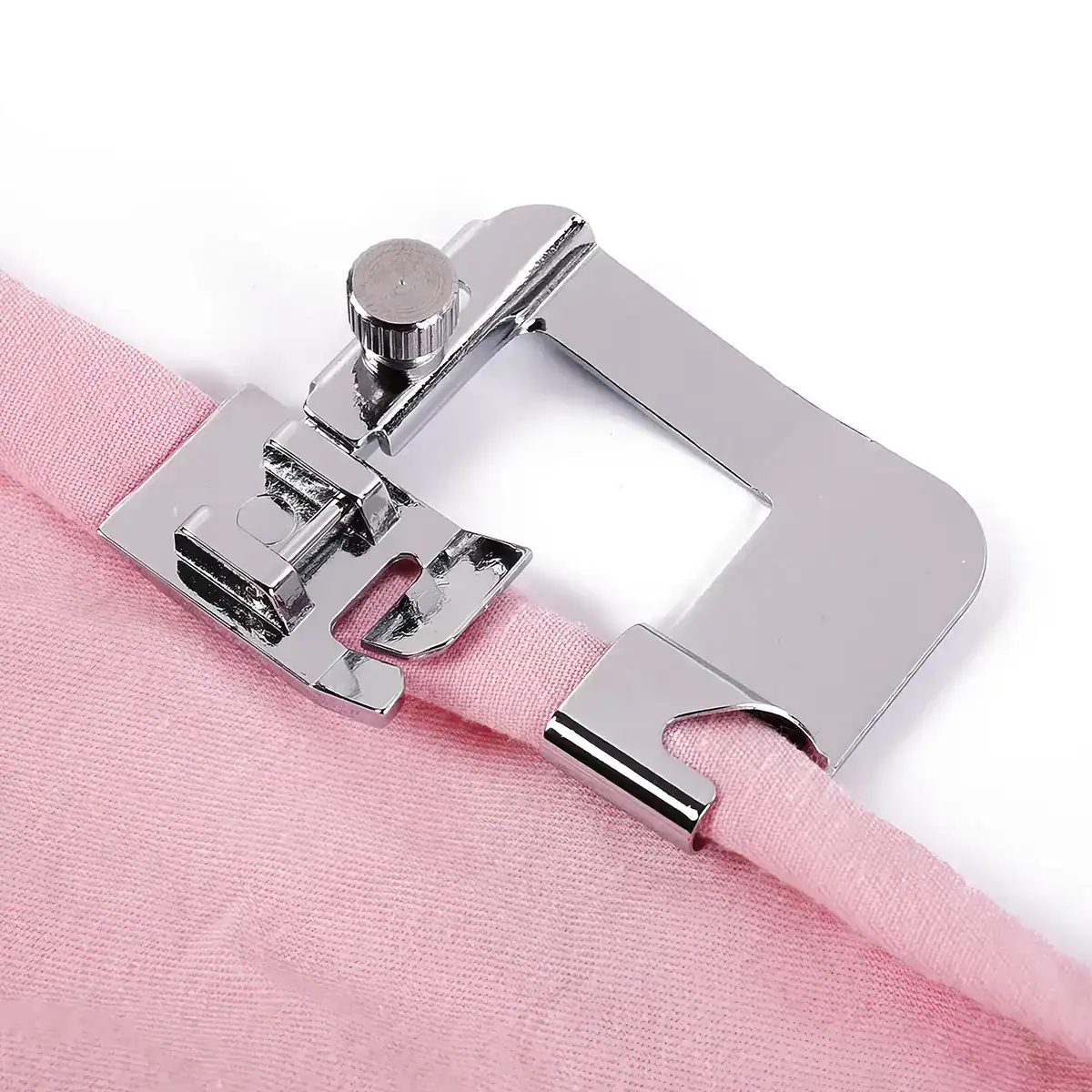 Close-up of a metal sewing machine hook guiding pink fabric for precise stitching, ideal for clothing, crafts, and upholstery sewing projects.