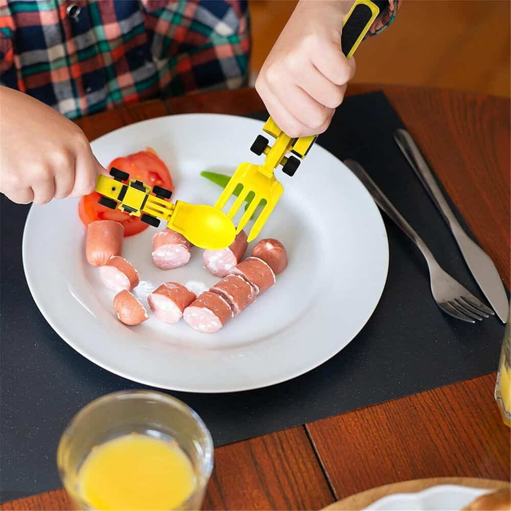 Child's playful meal with toy utensils and assorted mini sausages on a white plate, emphasizing nutritious and fun food choices for children.