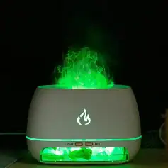 Ultrasonic diffuser emitting green mist with internal lighting, designed for essential oils and air purification, ideal for wellness and spa environments.