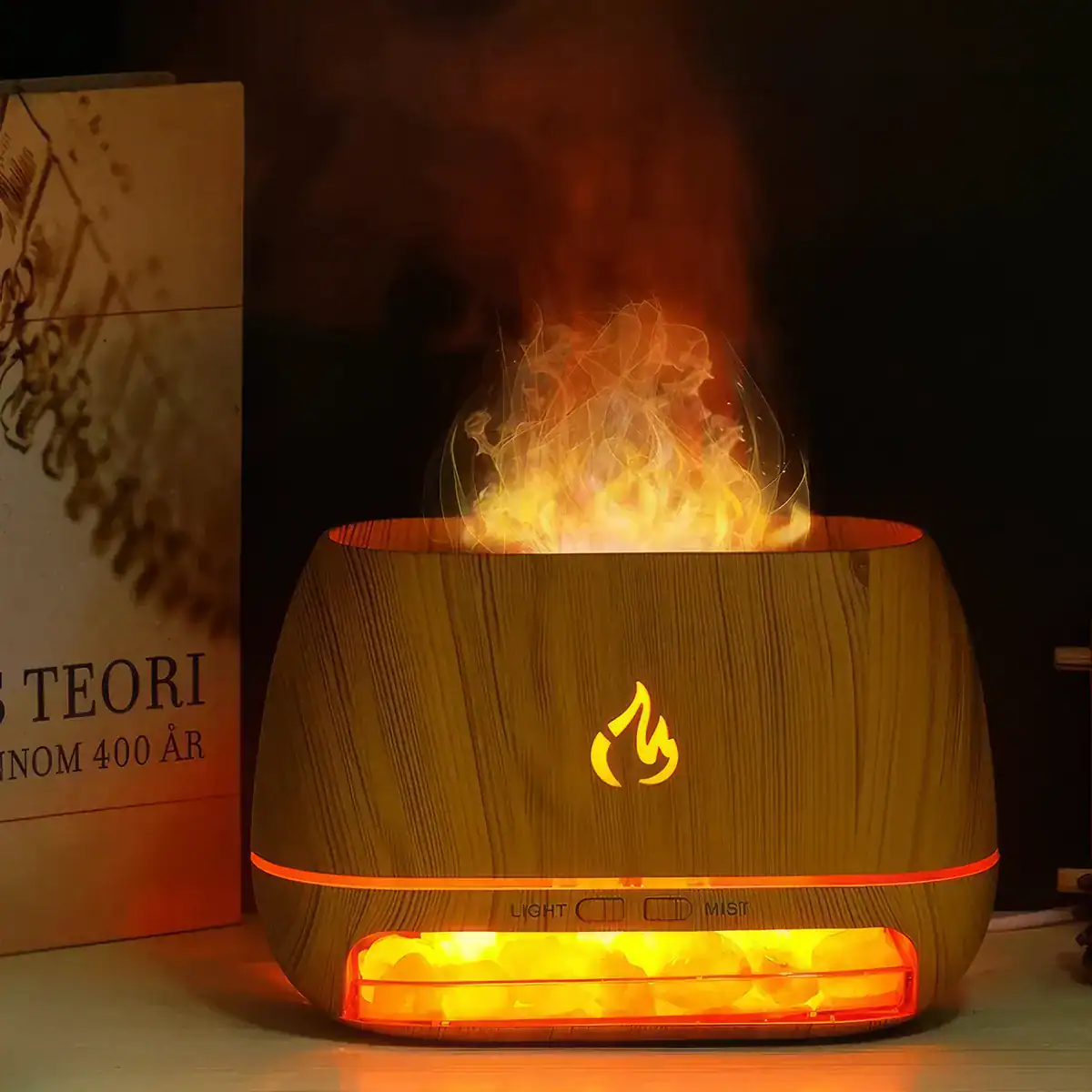 A modern wooden-style essential oil diffuser featuring a captivating flame-like light display and mist vapor, designed to create a calming and aromatic atmosphere in any space.