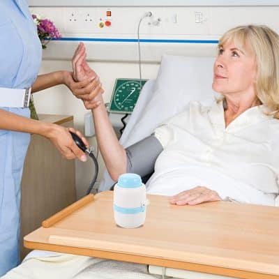 A healthcare professional checks a senior woman's vital signs with portable medical devices in a hospital room. Focus on patient monitoring, medical accuracy, and senior healthcare services.
