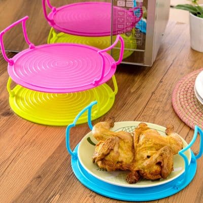 Bright pink and yellow steamers with handles designed for easy use and storage, suitable for busy kitchens and healthy meal prep.