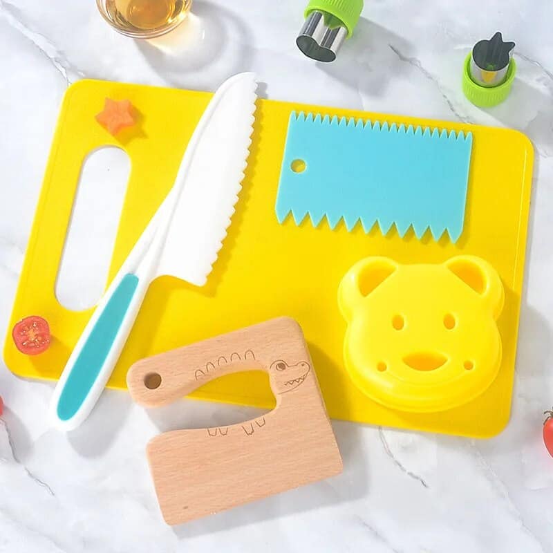 Child-safe knife and fun cutting board set for kids, perfect for safe cooking and food play. Bright colors and playful designs make cooking fun for children learning kitchen skills.