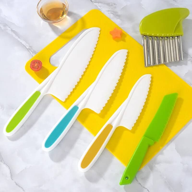 Colorful plastic knives set for cooking and food preparation, ideal for slicing fruits, vegetables, and cheese with safety and precision. Includes a green safety knife and a food slicer.